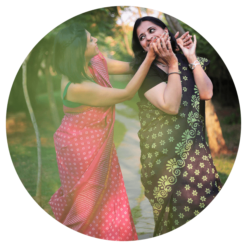 Two female models playing in a garden wearing Pink and Green sarees respectively from Luka Chuppi collection of Seven Sarees.