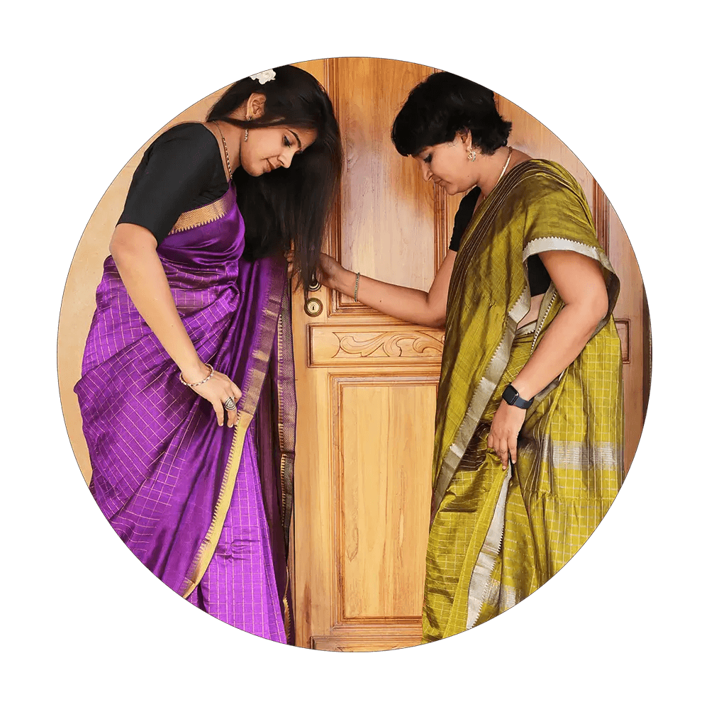 Two female models standing in front of a door in Pink and green Managalari sarees from Ekaika collection of Seven Saree.