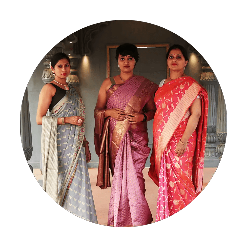 Three female models standing in a palace wearing Grey, Pink & Orange sarees from Kaashi Ki Kahaani collection of Seven Sarees
